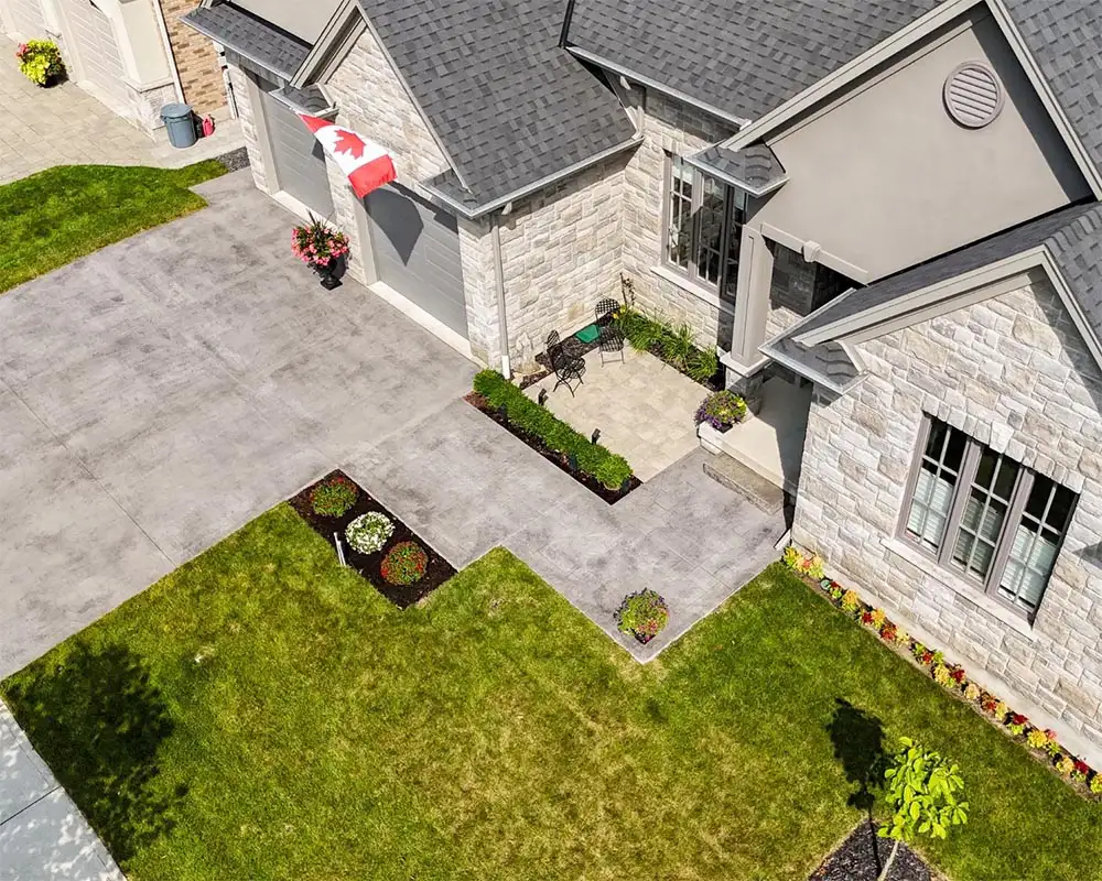 Large concrete driveway that also acts as a walkway to the house’s entrance