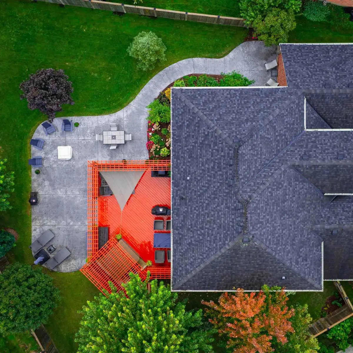 Large concrete patio with a walkway and multiple seating areas