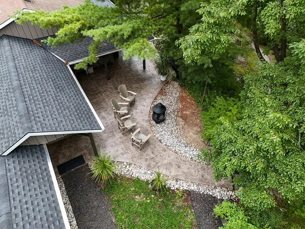 Finished patio and outdoor living space with chairs and a fire pit