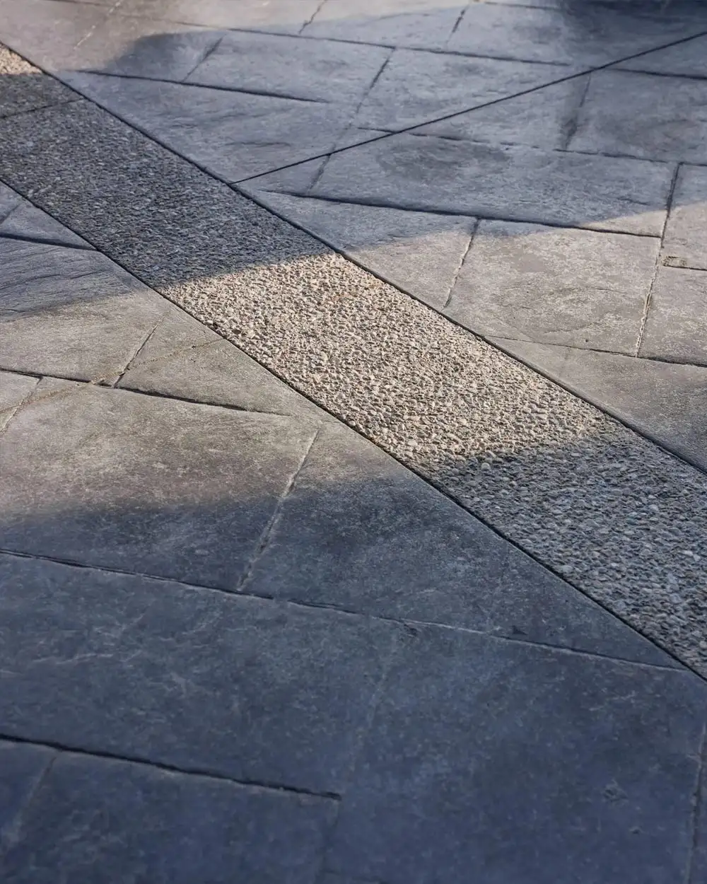 Close up of stamped concrete work with a divider line going through it