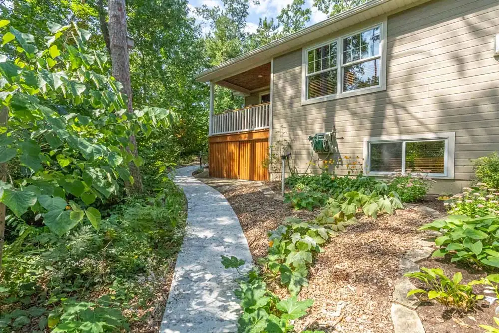 Residential concrete walkway on the side of a house