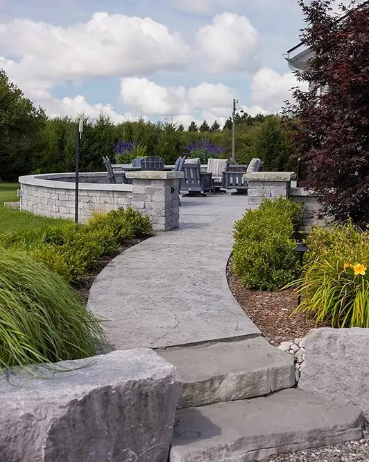 A concrete walkway leading to a lounge area